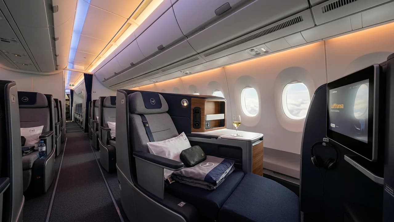 Lufthansa business class cabin with lie-flat suite and premium amenities