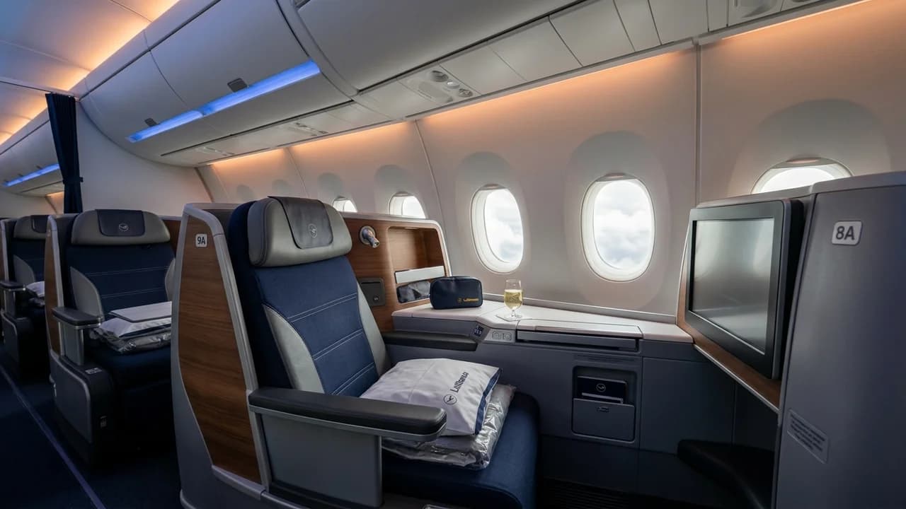 Lufthansa business class cabin with lie-flat suite and premium amenities