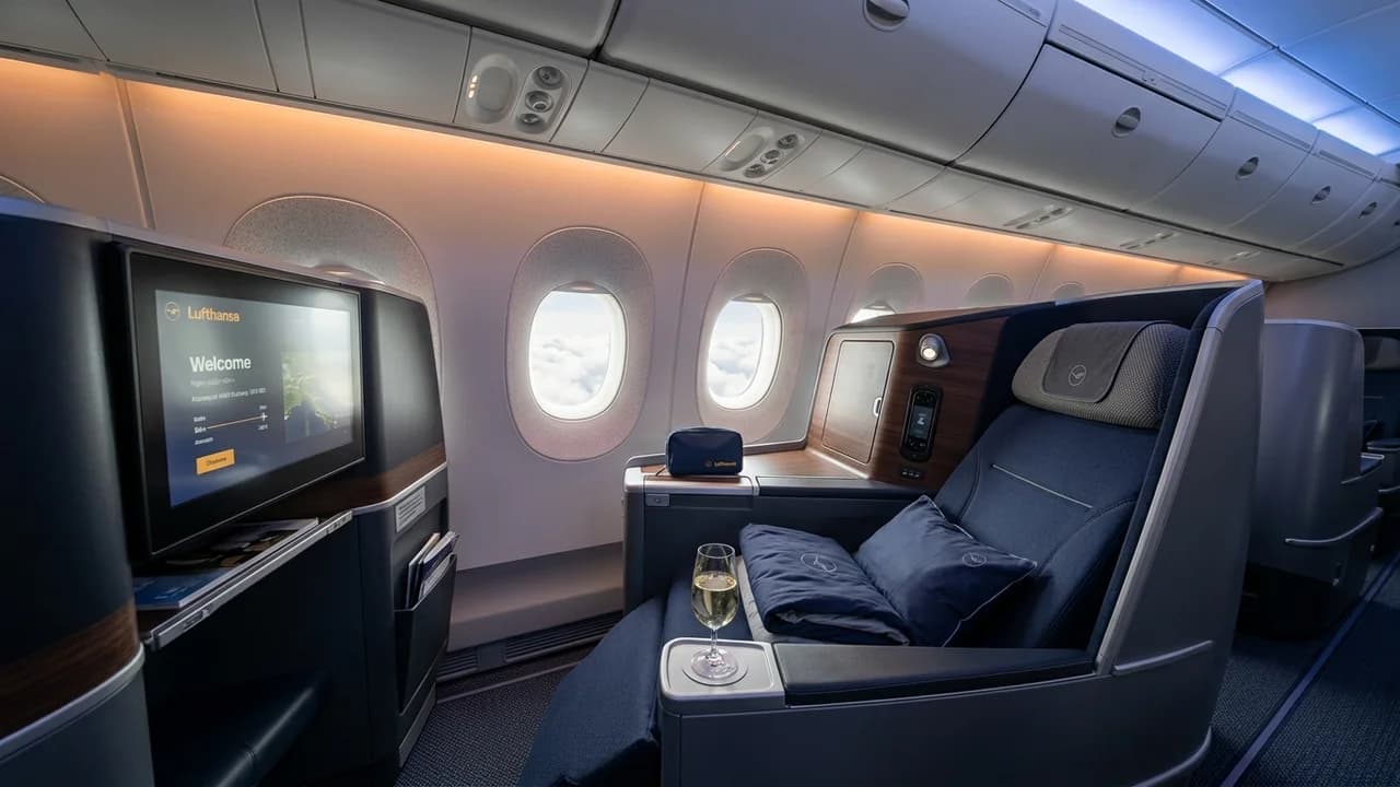 Lufthansa business class cabin with lie-flat suite and premium amenities